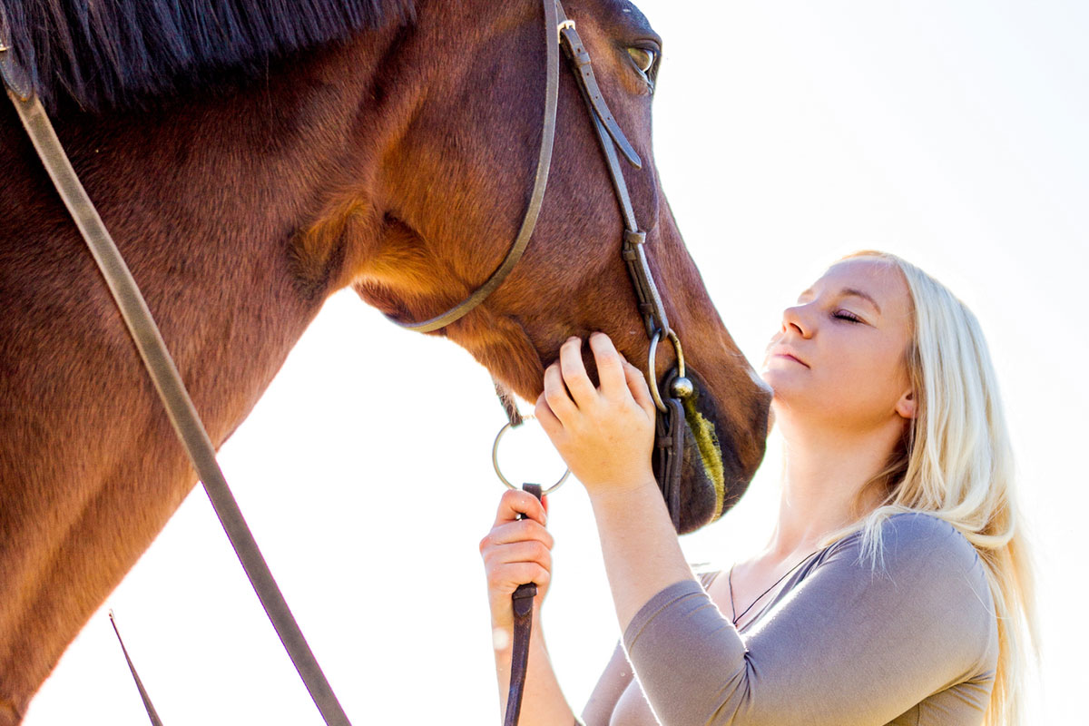 Young girl connecting with therapy horse